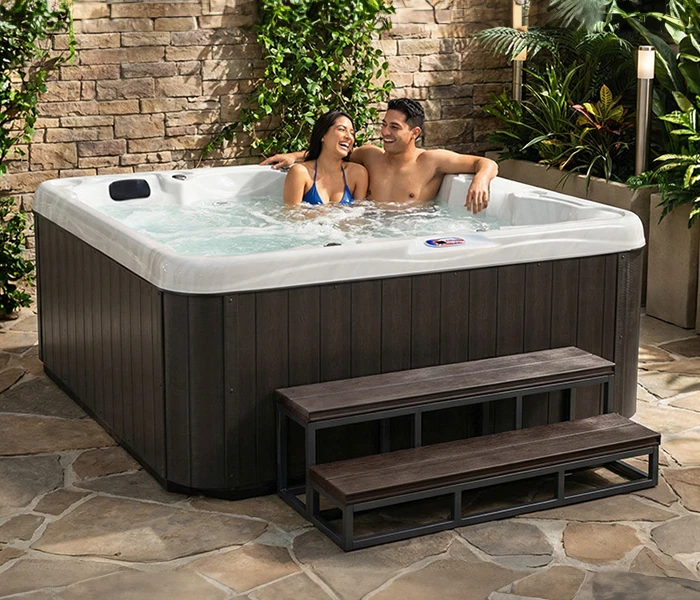 Hot Tubs, Spas, Portable Spas, for sale American Spas American Spas hot tub being used in a family setting